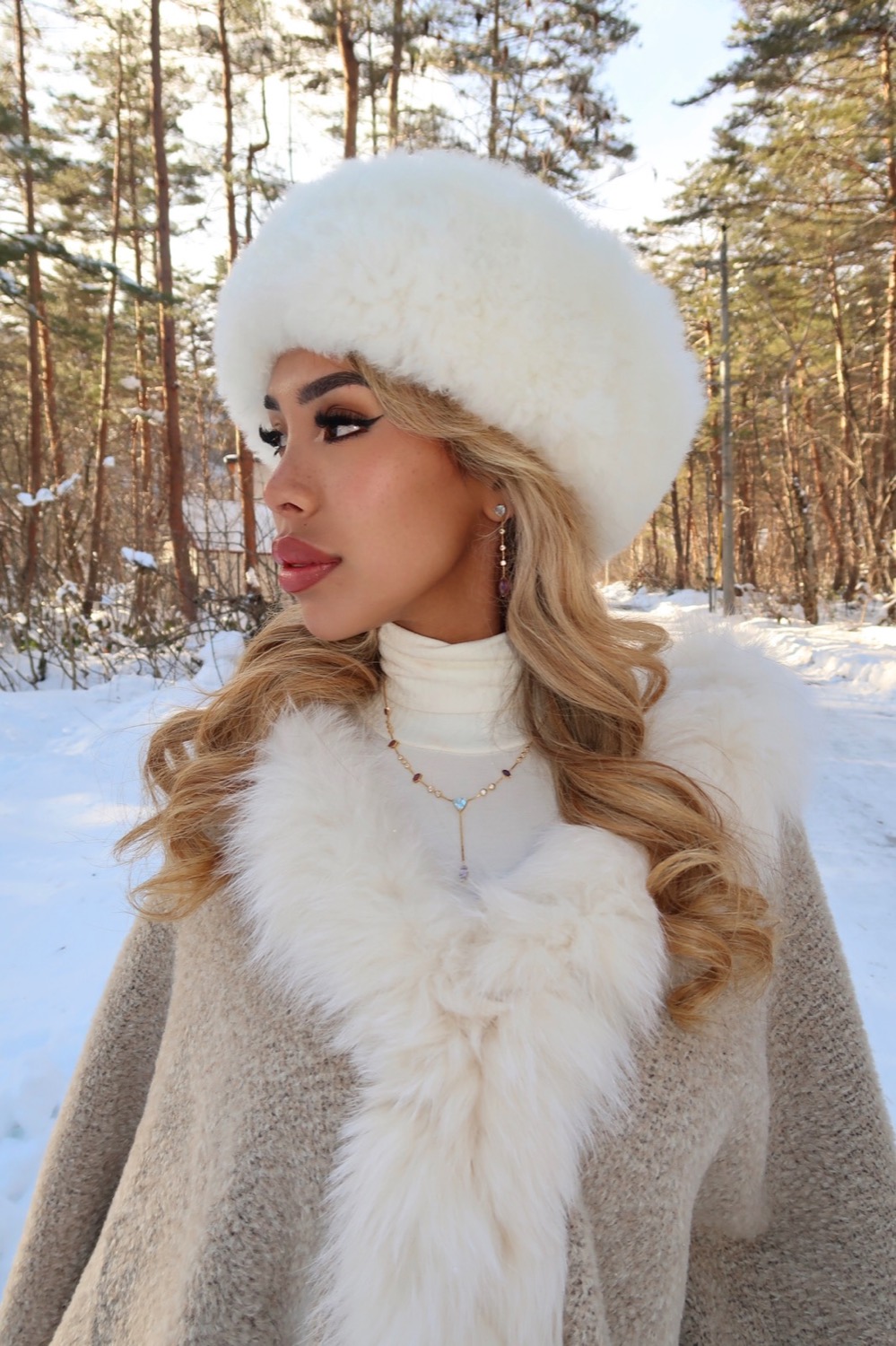 Model wearing Topaz necklace and earring in a snowy outdoor setting
